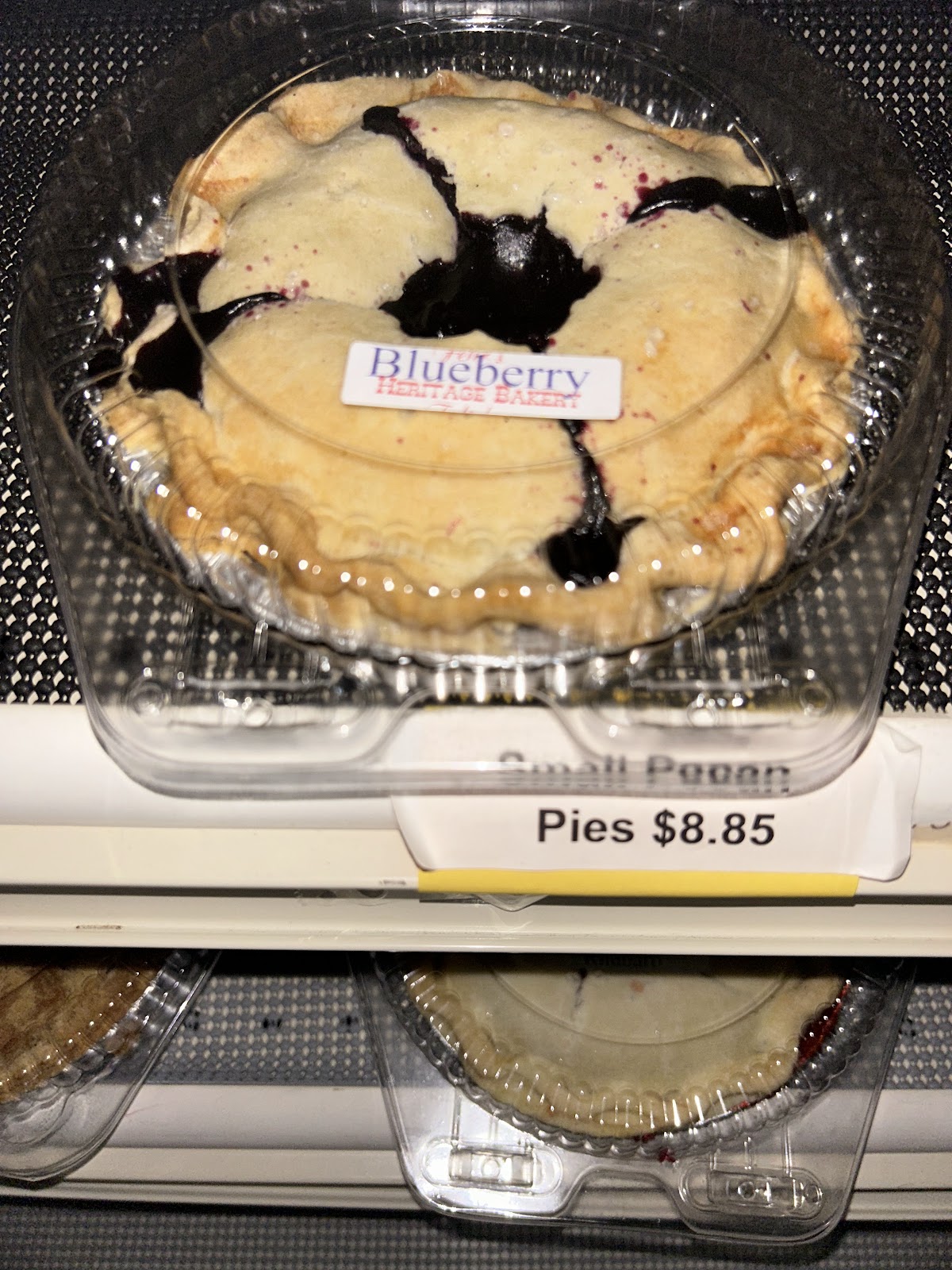 A fresh blueberry pie with golden flaky crust and fruit bubbling through the top at Fehr's Heritage Bakery